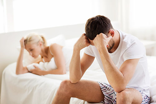disappointed couple in bed